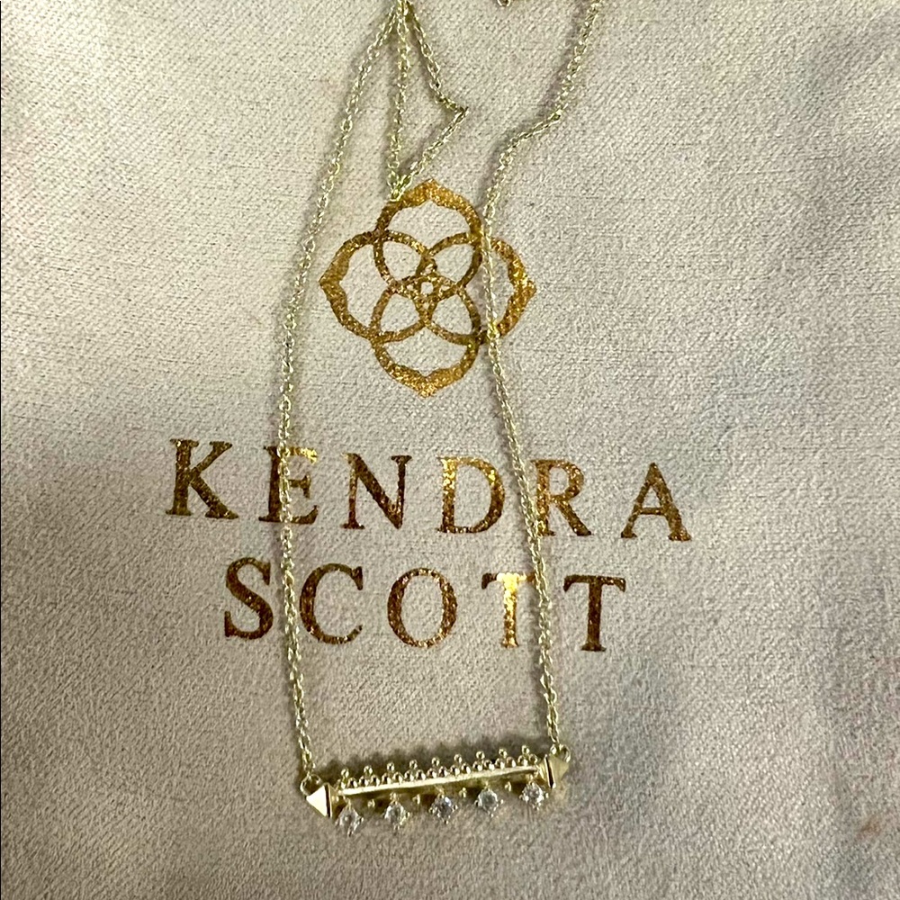 Gold w/rhinestone bar. Brand new. Never worn.